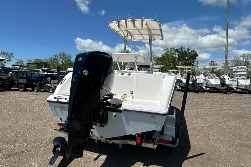 Slide: The Image of 2023 LFG 22 CC boat with outboard motor in a sunny outdoor setting. - 5