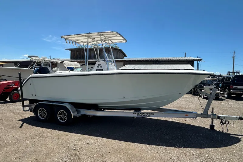 Slide: The Image of 2023 LFG 22 CC boat on trailer under clear blue sky. - 8