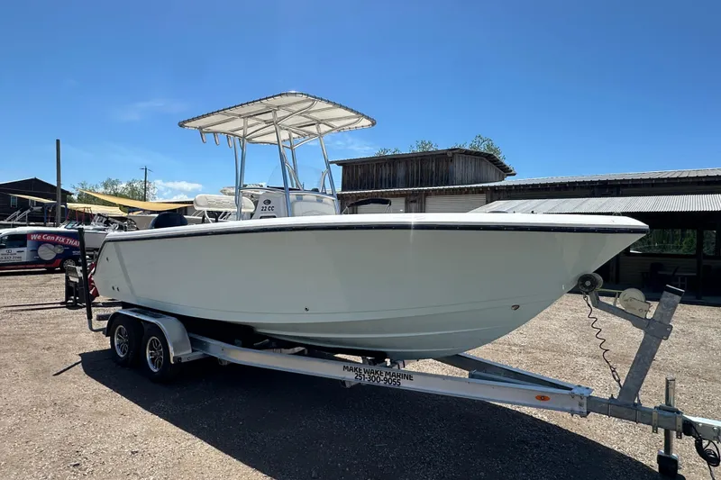 Slide: The Image of 2023 LFG 22 CC boat on trailer under clear blue sky. - 9