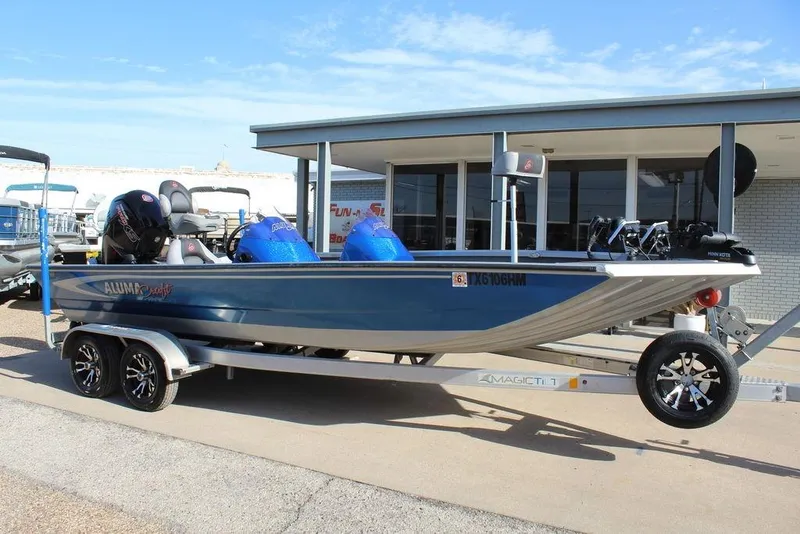 Slide: The Image of 2019 Alumacraft XB 200 boat on trailer, parked outside a building. - 3