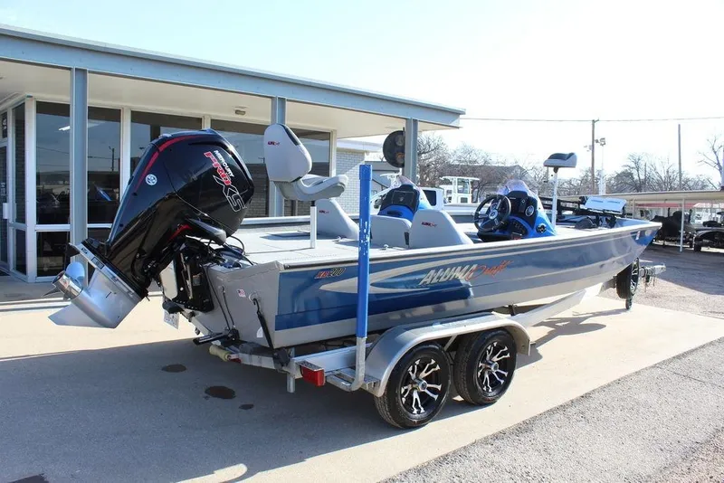 Slide: The Image of 2019 Alumacraft XB 200 boat on trailer, featuring powerful outboard motor. - 4