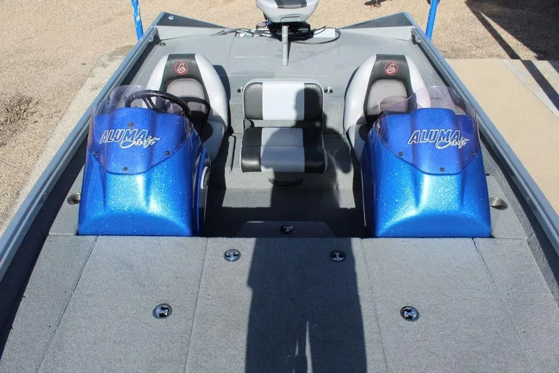 Slide: The Image of 2019 Alumacraft XB 200 boat interior with dual blue consoles and seating. - 6