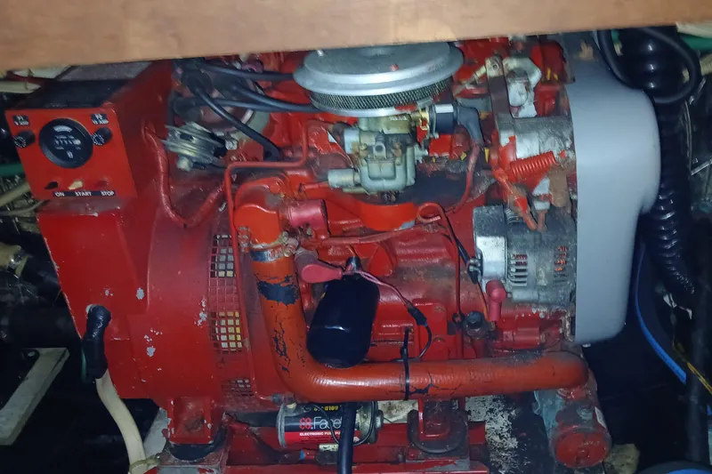 Slide: The Image of Engine compartment of a 1988 Carver 36 Command Bridge, featuring a red marine engine. - 10