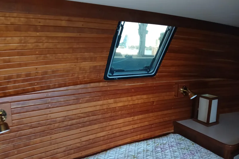 Slide: The Image of Interior of 1988 Carver 36 Command Bridge with wood paneling and window. - 2