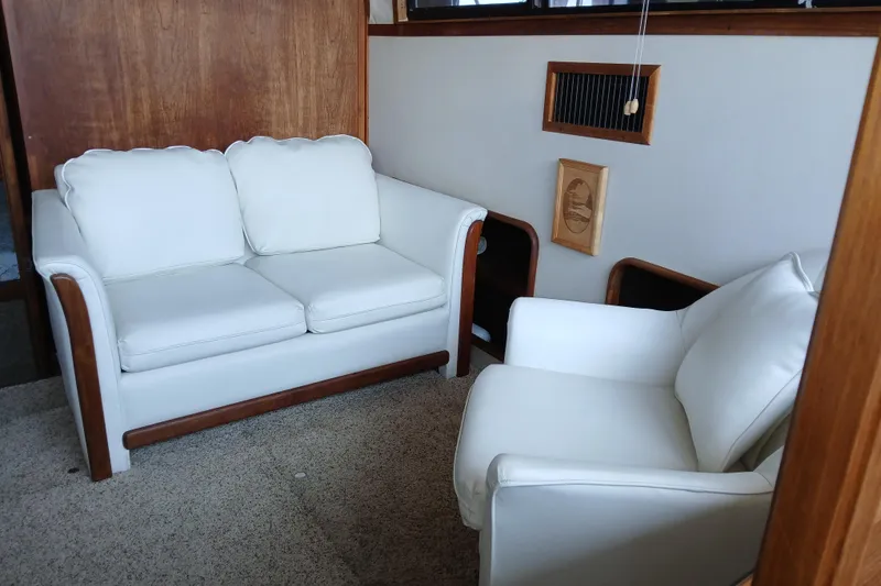 Slide: The Image of Interior of 1988 Carver 36 Command Bridge with white seating and wooden accents. - 3
