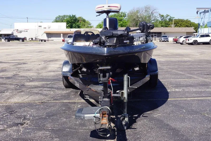 Slide: The Image of 2010 Bass Cat Cougar boat on trailer in parking lot, front view. - 12