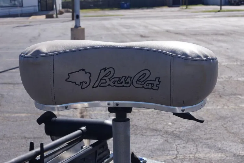 Slide: The Image of Bass Cat Cougar 2010 boat seat with logo in a parking lot. - 16