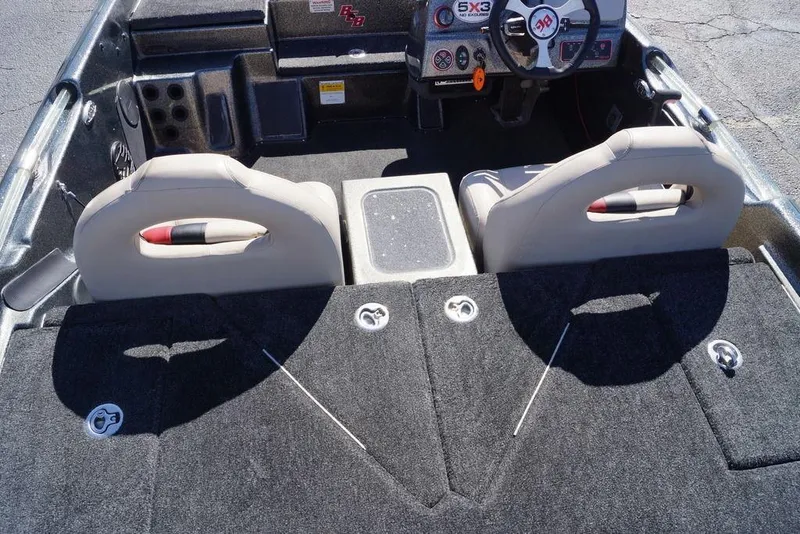 Slide: The Image of 2010 Bass Cat Cougar boat interior with dual seats and steering console. - 17