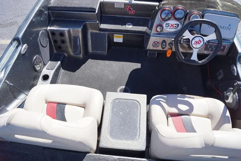 Slide: The Image of 2010 Bass Cat Cougar boat interior with steering wheel and dashboard controls. - 19