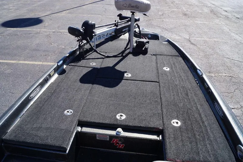 Slide: The Image of 2010 Bass Cat Cougar boat deck with trolling motor and carpeted surface. - 22