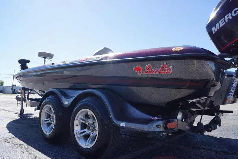 Slide: The Image of 2010 Bass Cat Cougar boat on trailer, featuring sleek design and Mercury engine. - 23