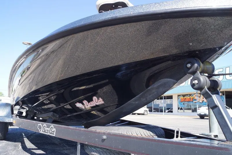 Slide: The Image of 2010 Bass Cat Cougar boat on trailer, showcasing sleek black hull design. - 3