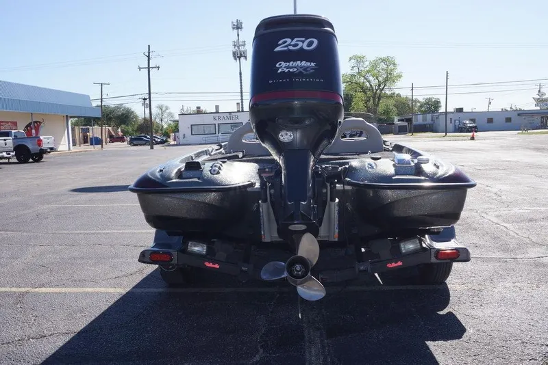 Slide: The Image of 2010 Bass Cat Cougar boat with OptiMax Pro 250 engine in a parking lot. - 4