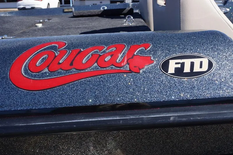 Slide: The Image of 2010 Bass Cat Cougar FTD logo on a glittery boat surface. - 6