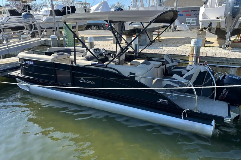 The Image of 2022 Barletta Cabrio 22CC pontoon boat docked, featuring sleek design and comfortable seating. - 0