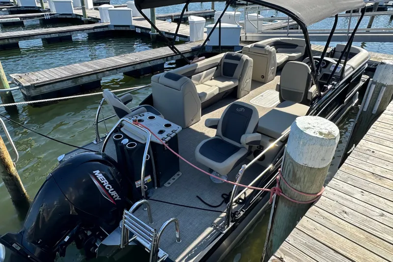 Slide: The Image of 2022 Barletta Cabrio 22CC pontoon boat docked with Mercury outboard engine. - 12