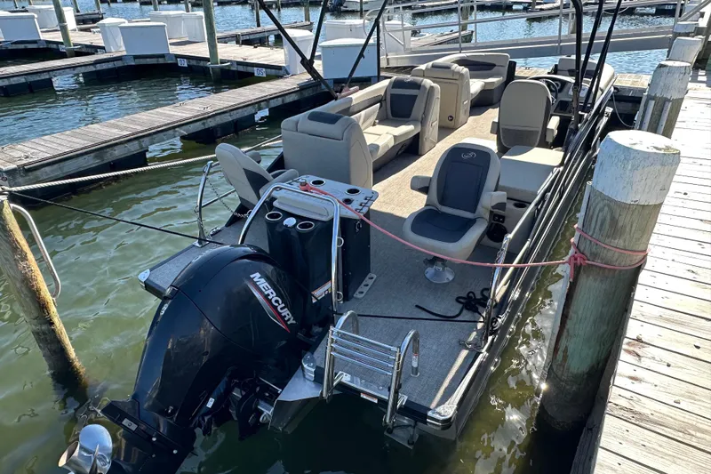Slide: The Image of 2022 Barletta Cabrio 22CC pontoon boat docked with Mercury outboard motor. - 13