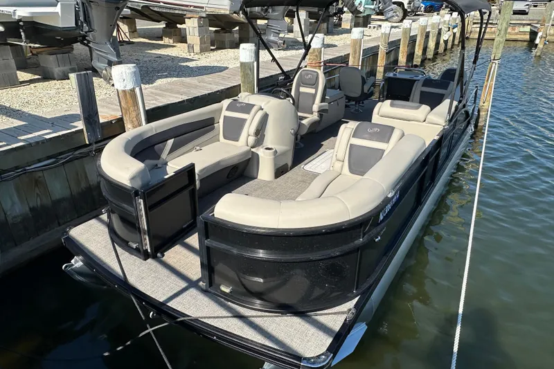 Slide: The Image of 2022 Barletta Cabrio 22CC pontoon boat docked, featuring spacious seating and modern design. - 2