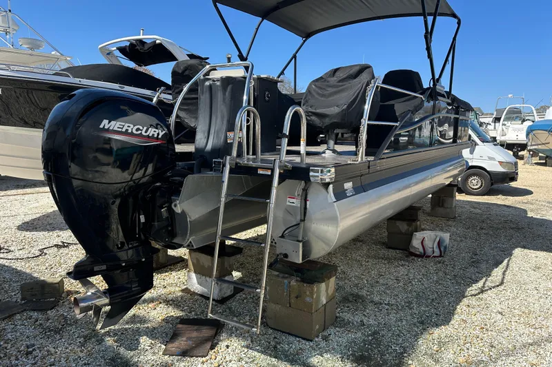 Slide: The Image of 2022 Barletta Cabrio 22CC pontoon boat with Mercury outboard motor on display. - 21
