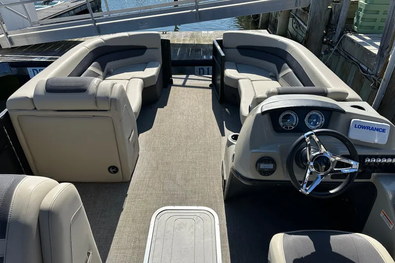 Slide: The Image of Interior of 2022 Barletta Cabrio 22CC pontoon boat with plush seating and modern dashboard. - 5
