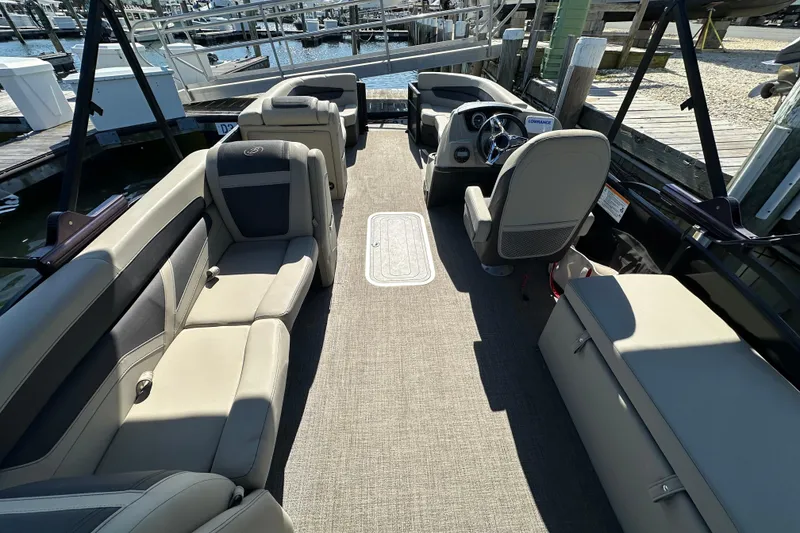 Slide: The Image of 2022 Barletta Cabrio 22CC pontoon boat interior with spacious seating and modern helm. - 7