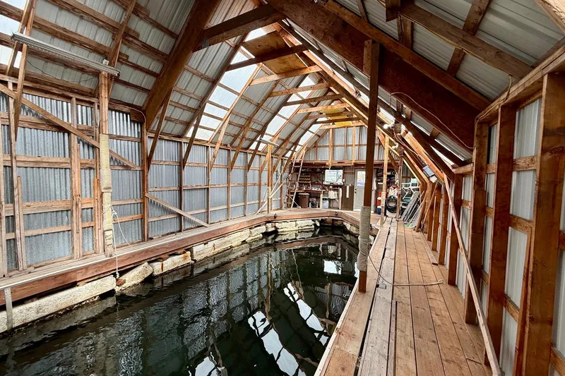 Slide: The Image of Wooden boathouse interior with water dock, BoatHouse model 19x43, built in 1990. - 6