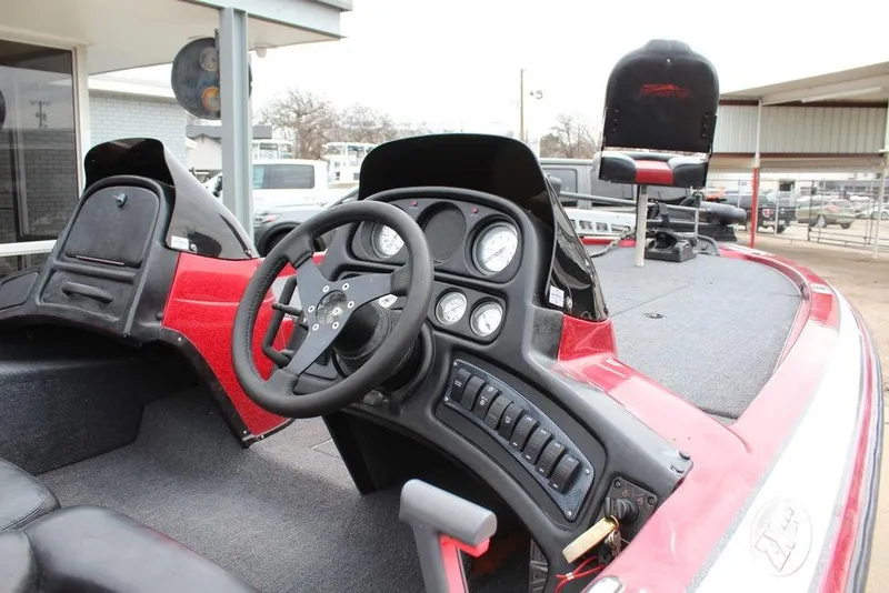 Slide: The Image of 2002 Skeeter ZX225 boat interior with steering wheel and dashboard controls. - 13