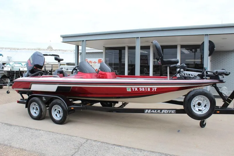 Slide: The Image of 2002 Skeeter ZX225 bass boat on trailer, parked outside a dealership. - 3