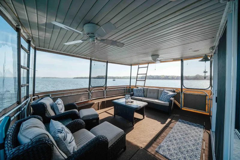 Slide: The Image of Luxurious 2009 Horizon 18x85 houseboat interior with wicker furniture and scenic lake view. - 11
