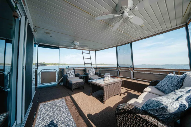 Slide: The Image of Spacious deck on 2009 Horizon 18x85 houseboat with wicker furniture and scenic lake view. - 12