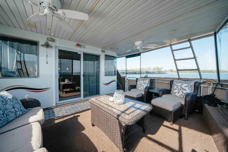Slide: The Image of Spacious deck of 2009 Horizon 18x85 houseboat with wicker furniture and lake view. - 13