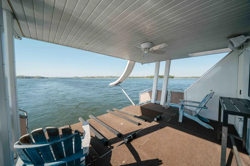 Slide: The Image of Covered deck of 2009 Horizon 18x85 houseboat with lake view and seating. - 14
