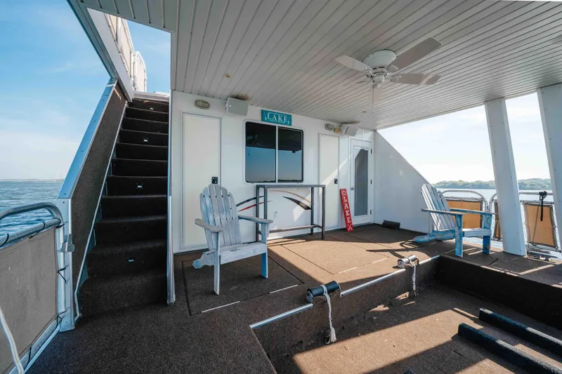 Slide: The Image of Upper deck of 2009 Horizon 18x85 houseboat with seating and lake view. - 16