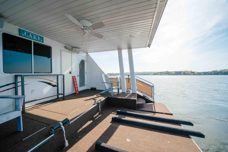 Slide: The Image of Houseboat deck overlooking serene lake, Horizon 18x85 model, 2009, with seating and ceiling fan. - 17