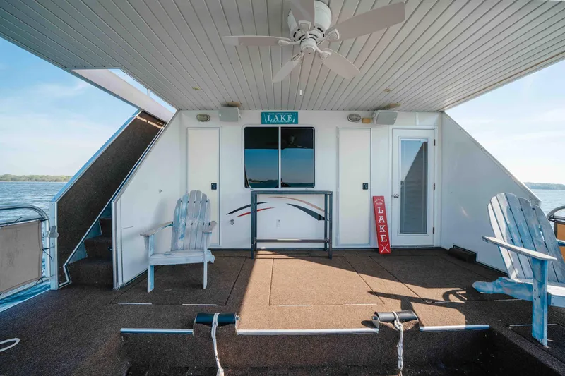 Slide: The Image of Houseboat deck with Adirondack chairs, ceiling fan, and lake view; Horizon 18x85, 2009 model. - 18