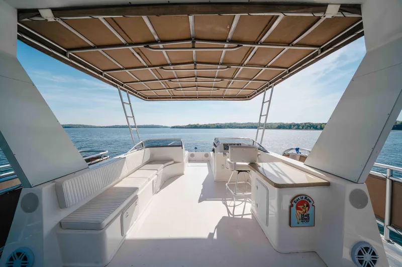 Slide: The Image of Spacious deck of 2009 Horizon 18x85 houseboat with seating and scenic lake view. - 23