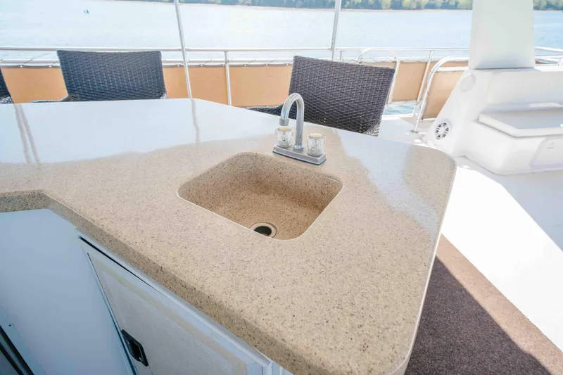 Slide: The Image of Luxury yacht Horizon 18x85 (2009) with elegant outdoor sink and seating area. - 32