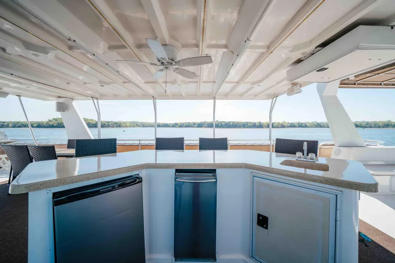 Slide: The Image of Luxurious Horizon 18x85 yacht deck with bar and seating, overlooking serene waters, 2009 model. - 33