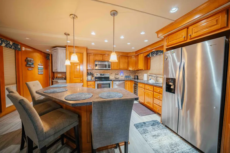 Slide: The Image of Luxurious kitchen in 2009 Horizon 18x85 houseboat with modern appliances and wooden cabinetry. - 37