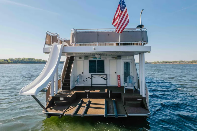 Slide: The Image of Houseboat with slide and American flag on a lake, Horizon 18x85, 2009 model. - 4