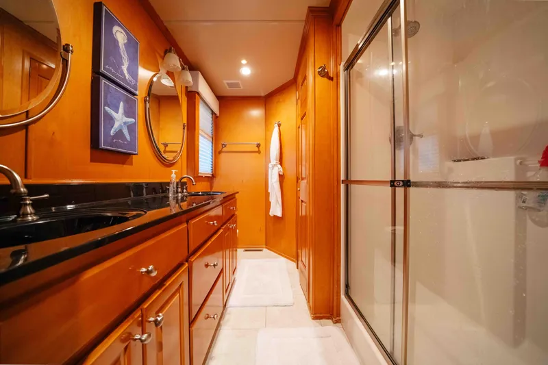 Slide: The Image of Luxurious bathroom in 2009 Horizon 18x85 houseboat with wooden cabinetry and glass shower. - 43