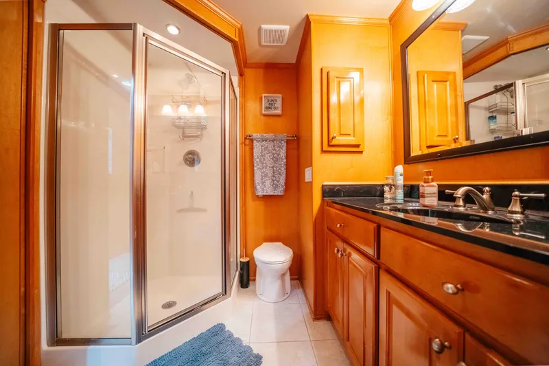 Slide: The Image of Luxurious bathroom in 2009 Horizon 18x85 houseboat with wooden cabinetry and modern fixtures. - 47