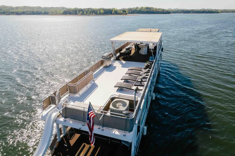 Slide: The Image of Luxurious 2009 Horizon 18x85 houseboat cruising on a serene lake under clear skies. - 5