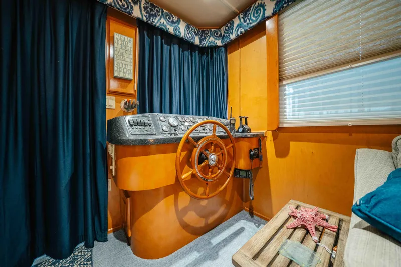 Slide: The Image of Pilothouse interior of 2009 Horizon 18x85 boat with wooden steering wheel and nautical decor. - 50