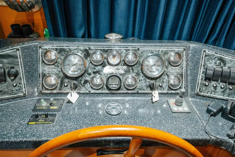 Slide: The Image of Control panel of a 2009 Horizon 18x85 yacht with gauges and switches. - 52