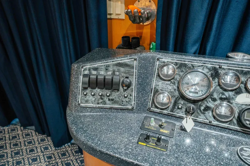 Slide: The Image of Control panel of a 2009 Horizon 18x85 boat with gauges and switches. - 54