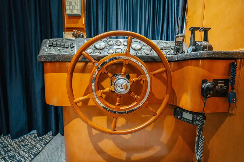 Slide: The Image of Wooden steering wheel on a 2009 Horizon 18x85 boat's control panel. - 55