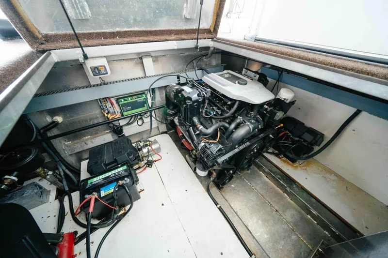Slide: The Image of Engine room of a 2009 Horizon 18x85 boat, featuring a well-maintained engine and battery setup. - 59