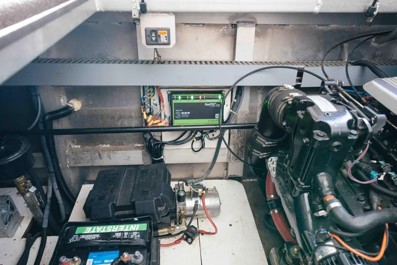 Slide: The Image of Engine room of 2009 Horizon 18x85 boat with battery and wiring components. - 60