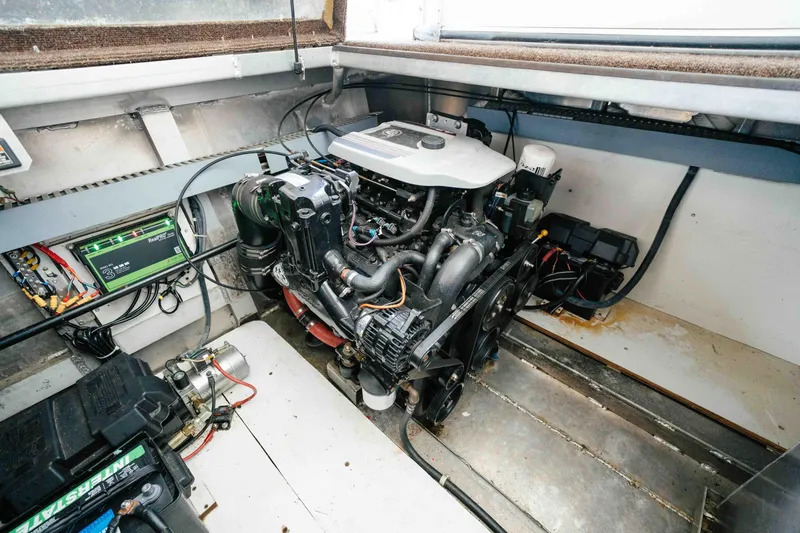 Slide: The Image of Engine room of a 2009 Horizon 18x85 boat, showcasing mechanical components and wiring. - 61